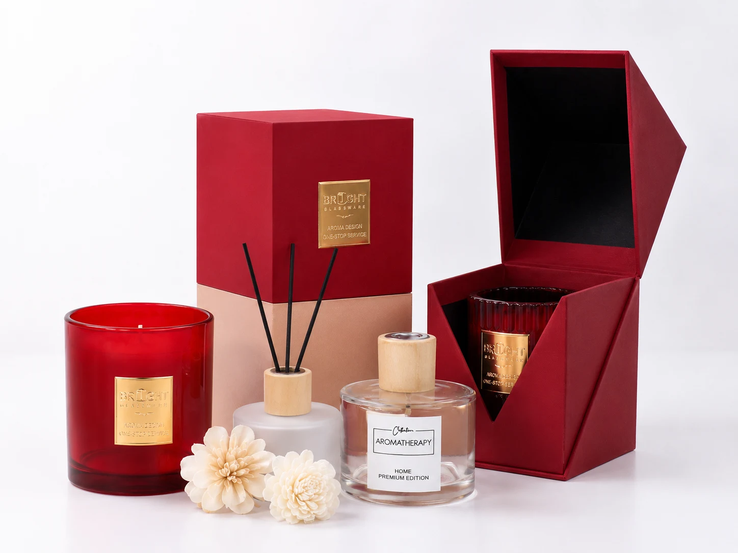 Custom candle brand packaging with red glass candle jar, rigid gift boxes, diffuser bottle, and premium decorative containers