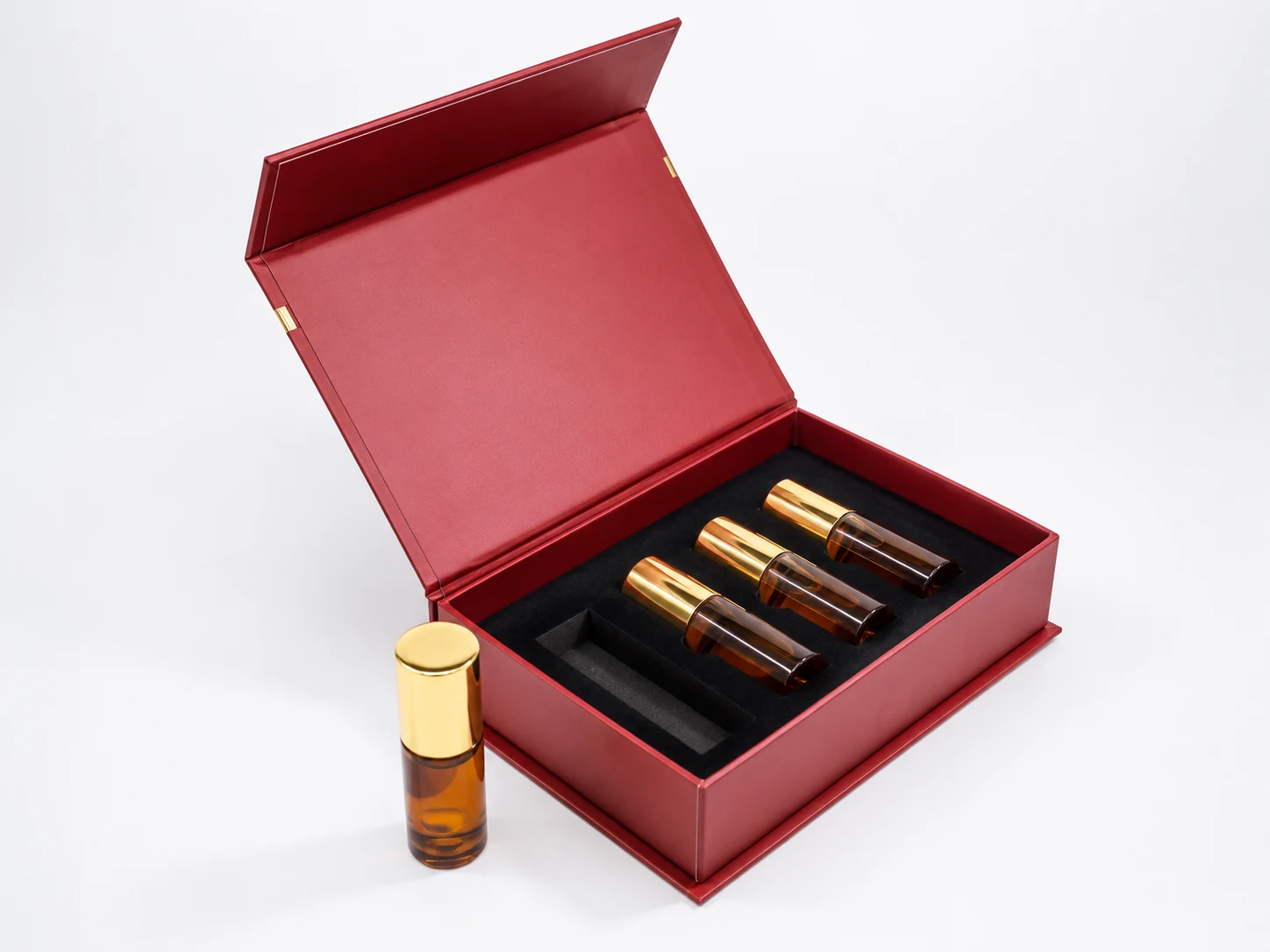 Luxury amber perfume vial set with rigid presentation box and matching gold cap mini bottles