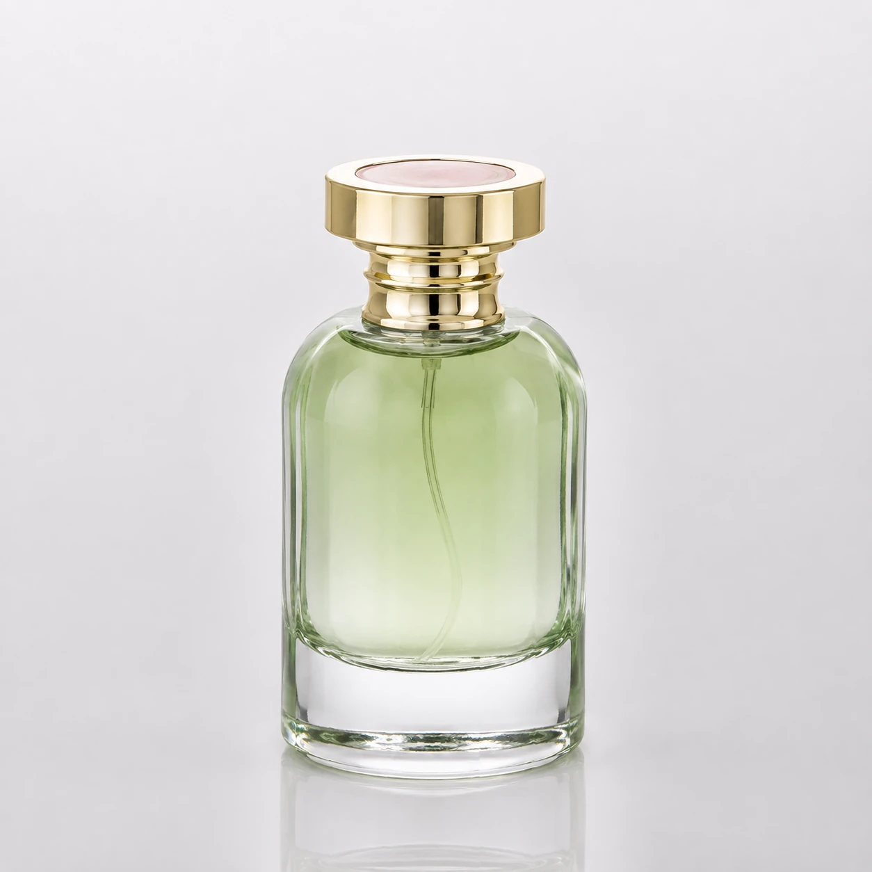 Light green round glass perfume bottle with gold cap