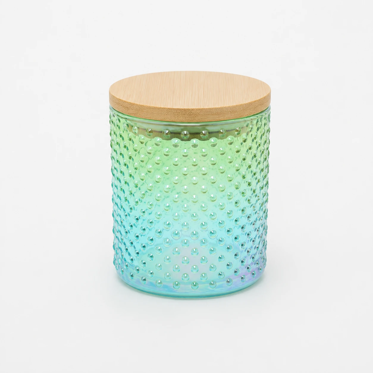 Iridescent green glass candle jar with textured surface and bamboo lid