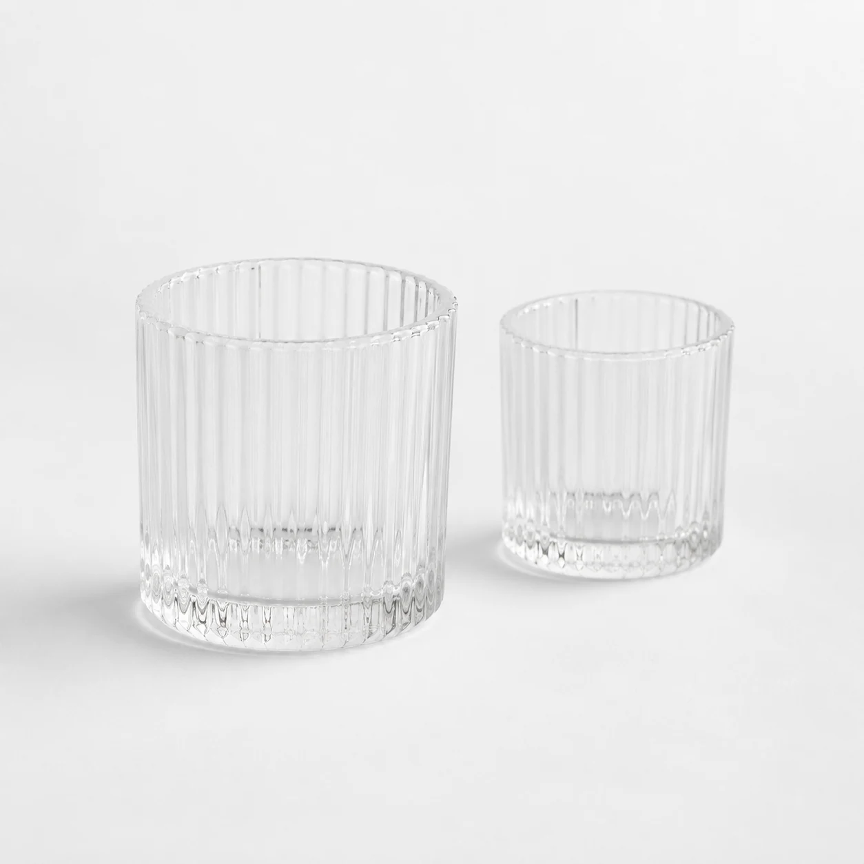 Clear fluted glass candle jars in two sizes