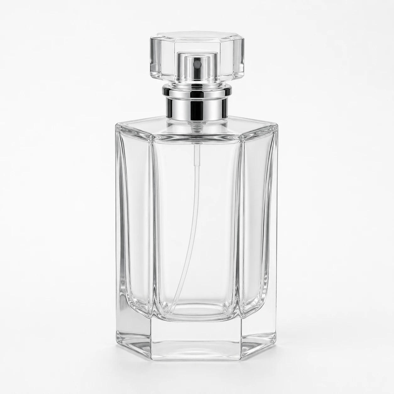 Clear hexagonal glass perfume bottle with silver spray pump and faceted cap