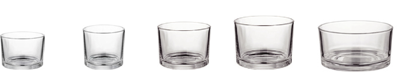 Five clear glass candle jars ranging from compact low tumblers to wider candle vessels