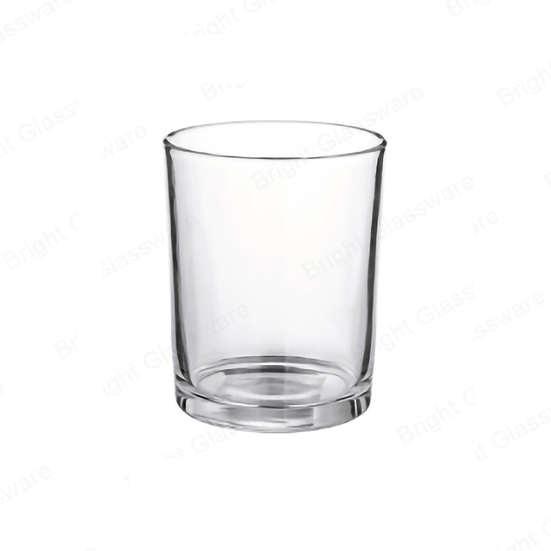 Tall clear glass candle tumbler with a thick visible base