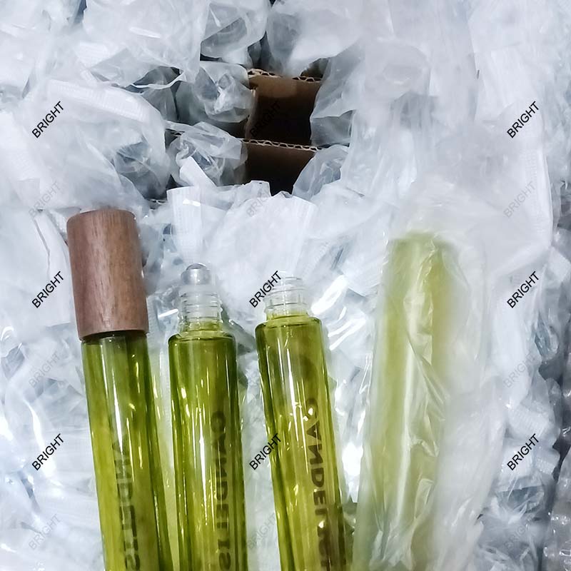 Glass roller bottles with individual bags and cardboard dividers