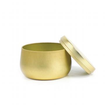 Gold-tone round metal candle tin with its lid removed