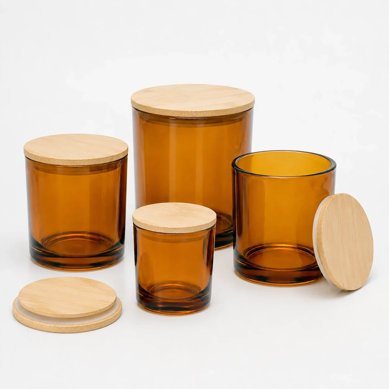 Amber glass candle jars in several sizes with matching wooden lids