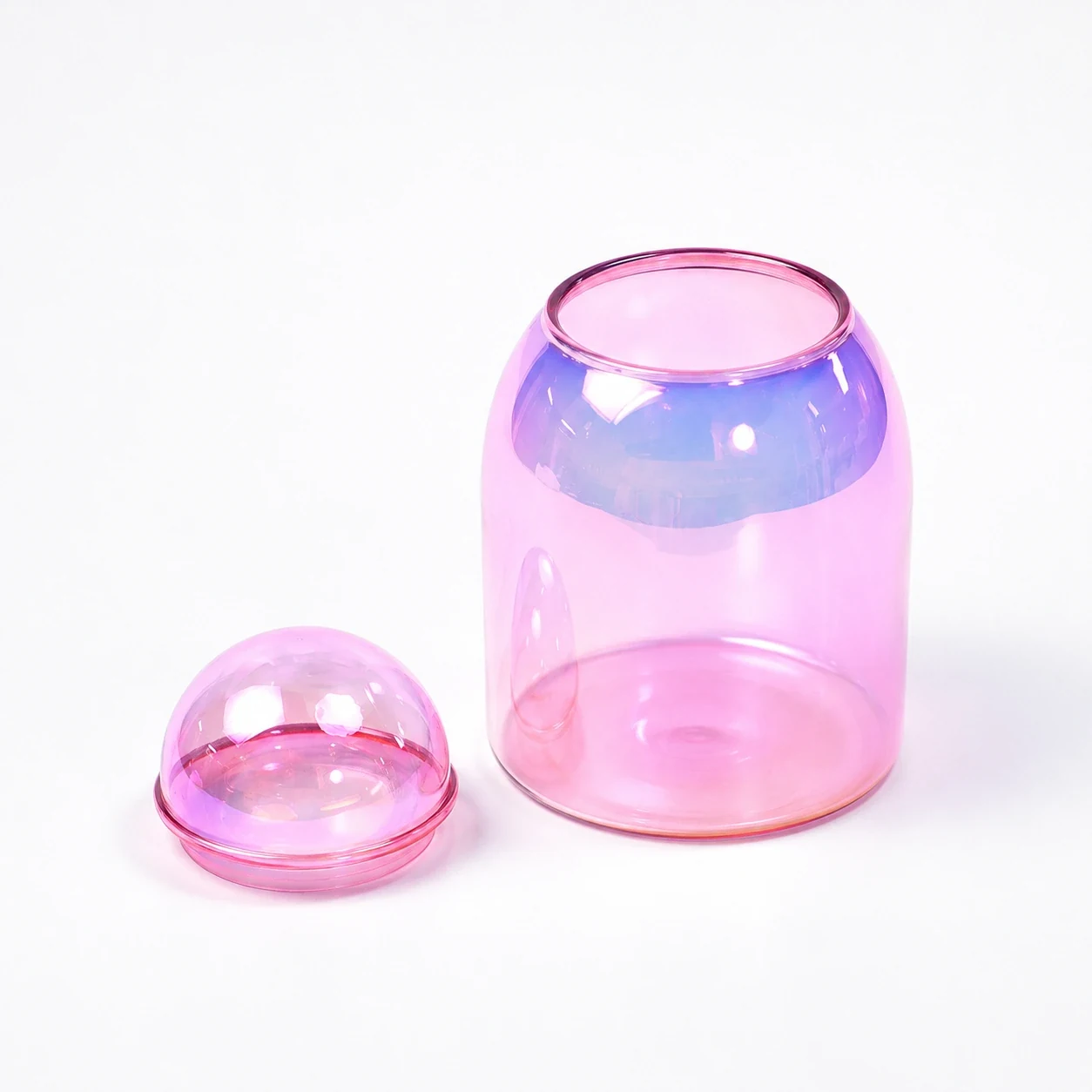 Pink translucent glass candle jar with a matching dome-shaped glass lid