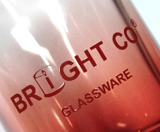 Bright Glassware logo printed on a glass container