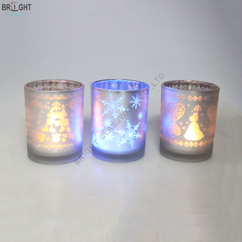 Illuminated glass candle holders with decorative patterns
