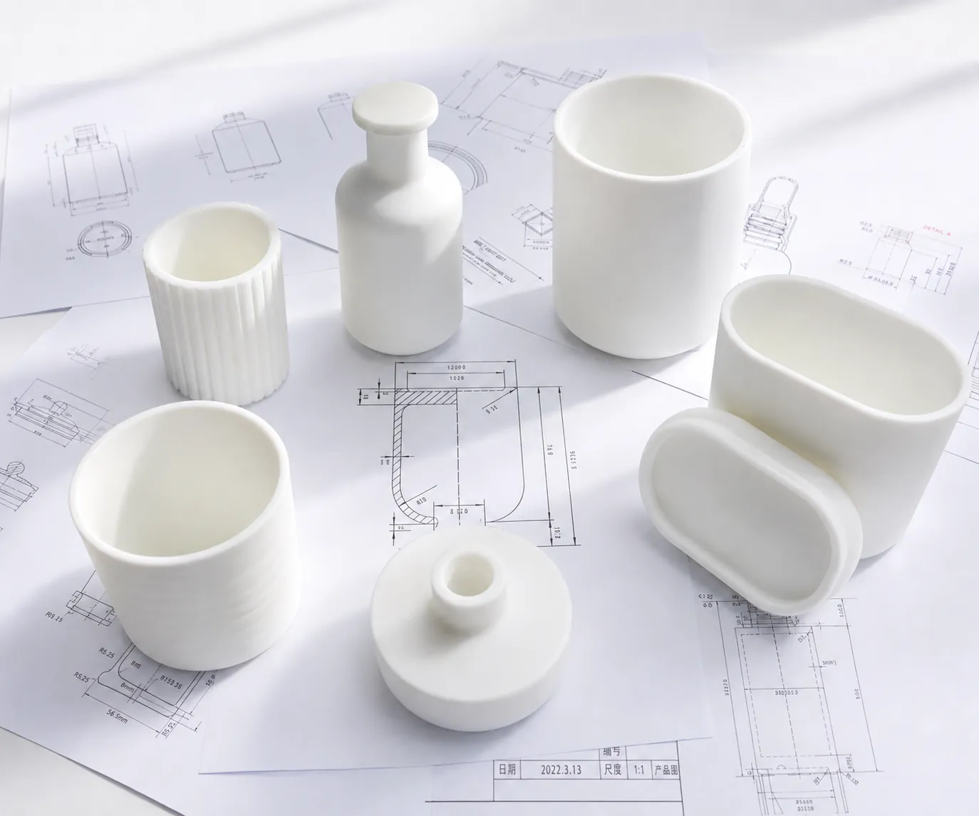 White prototype bottle and jar forms on technical drawings for validating packaging shape, dimensions and structure before tooling