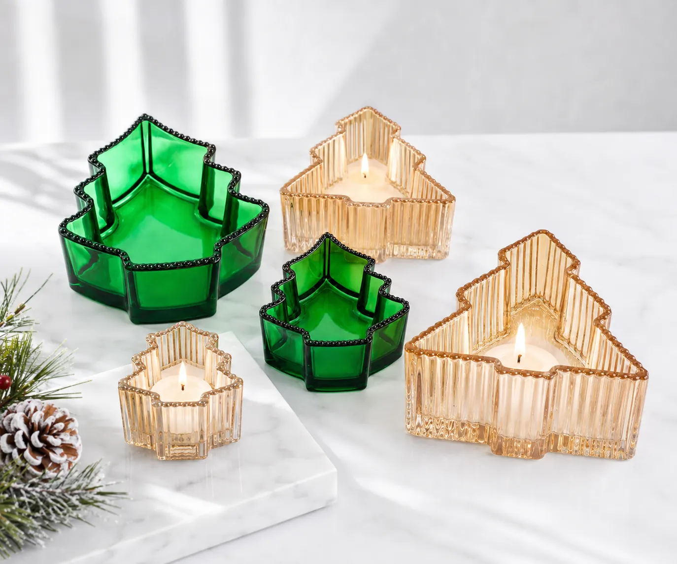 Christmas tree shaped glass candle containers in green and amber finishes for seasonal specialty packaging