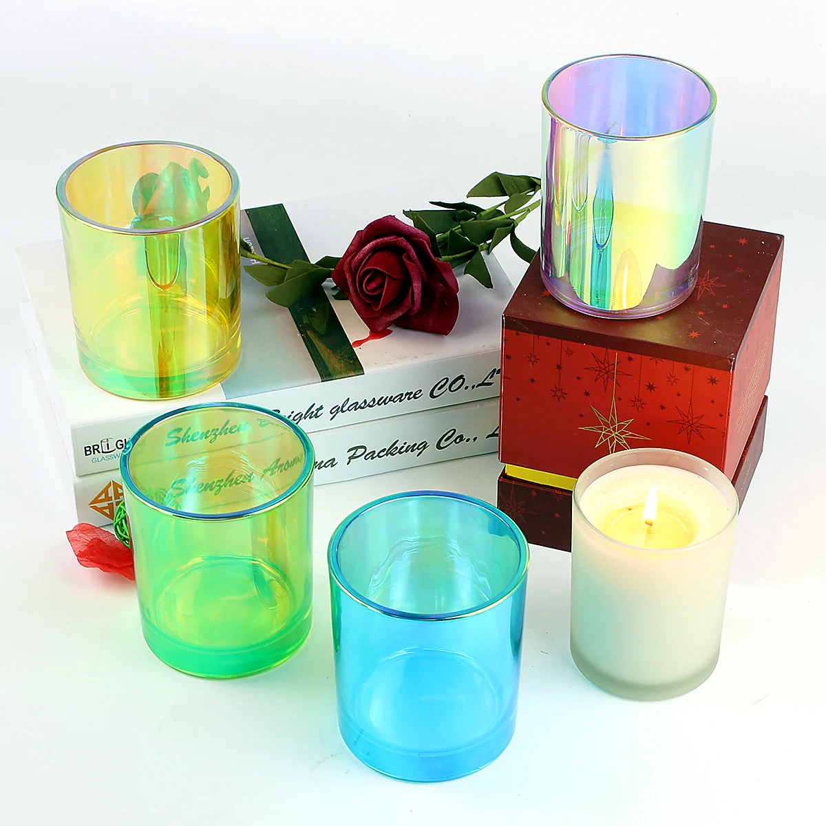 Iridescent electroplated glass candle jars with rainbow metallic surface effects and bamboo lids