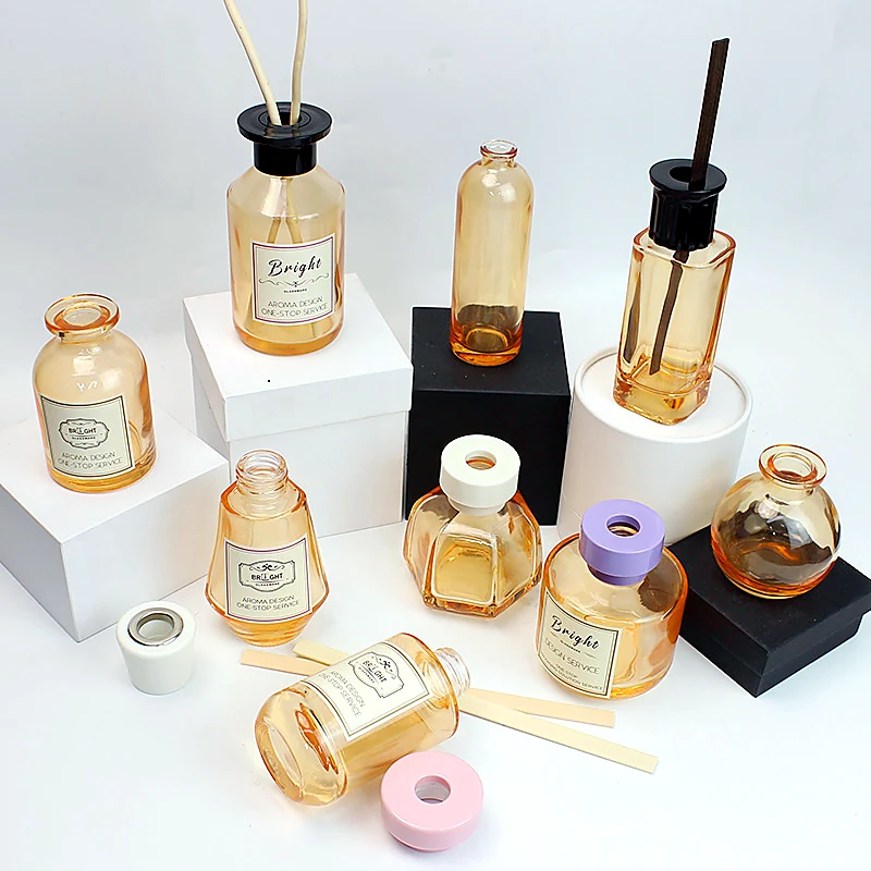 Amber glass diffuser bottle collection with custom labels, colored collars and reed accessories