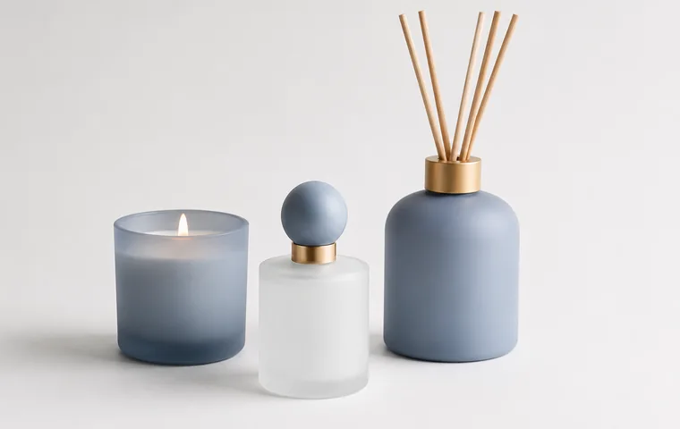 Matte finish glass packaging with blue gray candle, perfume and diffuser containers